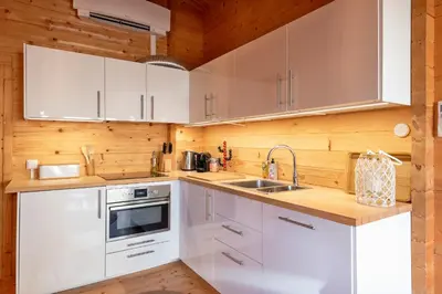 a kitchen with white cabinets and a sink at The Sea Lodge in Zandvoort
