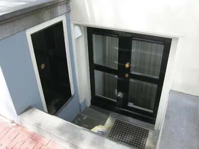 a black door on the side of a building at Amsterdam Canal Guest Apartment in Amsterdam