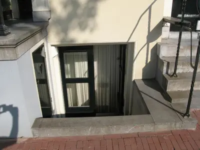 a door to a building with stairs and a window at Amsterdam Canal Guest Apartment in Amsterdam