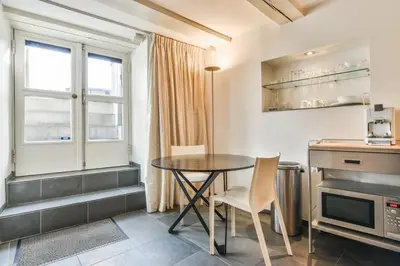 a kitchen with a table and chairs and a window at Amsterdam Canal Guest Apartment in Amsterdam