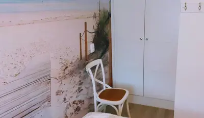 a room with a chair and a wall withdust at Close to the beach in Wijk aan Zee