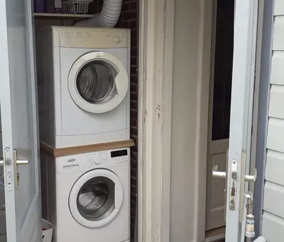 a washing machine and a washer in a doorway at Close to the beach in Wijk aan Zee