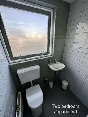 a bathroom with a toilet and a sink with a window at Appartementen in het centrum van Hoorn in Hoorn