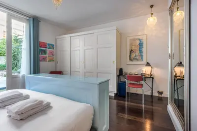 a bedroom with a bed and a desk with towels on it at The Old Lady in Amsterdam