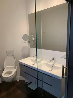 a bathroom with a toilet and a sink and a mirror at The Old Lady in Amsterdam