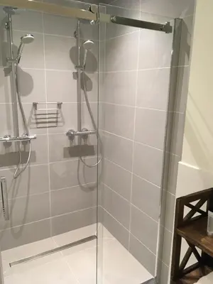 a shower with a glass door in a bathroom at The Old Lady in Amsterdam