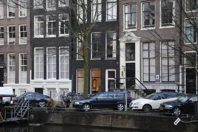 a group of cars parked in front of buildings at The Old Lady in Amsterdam