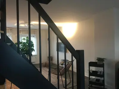 a room with a staircase with a light on the ceiling at Pakhuis 5 in Katwijk aan Zee