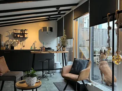 a kitchen and living room with a table and chairs at Pakhuis 5 in Katwijk aan Zee