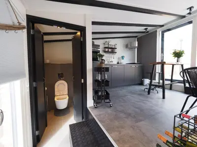 an open room with a kitchen and a toilet at Pakhuis 5 in Katwijk aan Zee