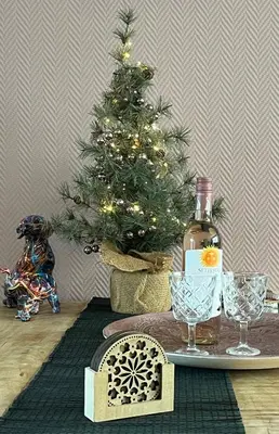 a christmas tree with a bottle of wine and glasses at Pakhuis 5 in Katwijk aan Zee