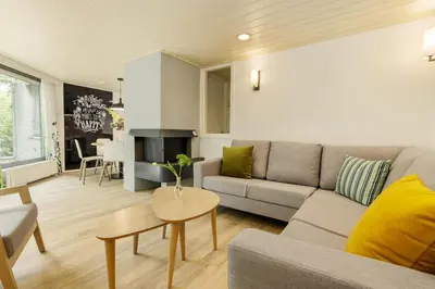a living room with a couch and a table at Center Parcs De Eemhof in Zeewolde