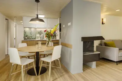 a dining room and living room with a table and chairs at Center Parcs De Eemhof in Zeewolde