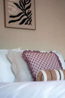 a bed with two pillows and a picture on the wall at Hotel het Oude Raadhuis in Castricum