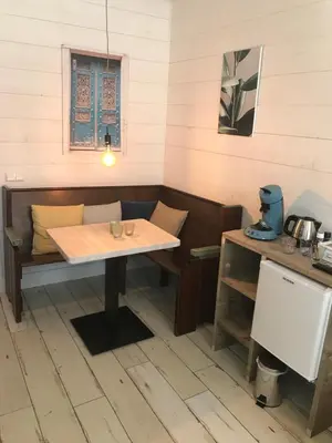 a table and a bench in a room at B&B de Petrakerk in Rijnsburg