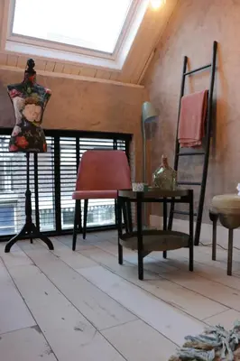 a room with a table and a chair and a window at B&B de Petrakerk in Rijnsburg