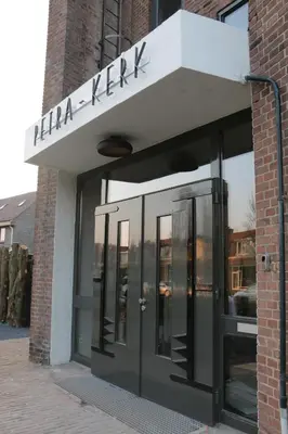 a building with a sign that reads haka kervik at B&B de Petrakerk in Rijnsburg