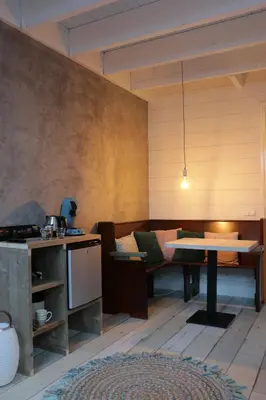 a living room with a table and a couch at B&B de Petrakerk in Rijnsburg