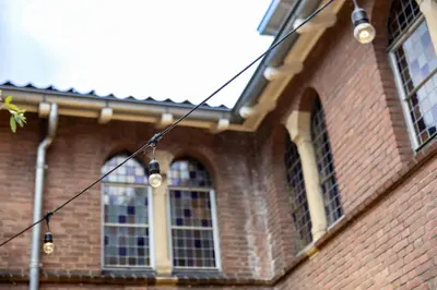 a brick building with windows and lights on it at The Anthony in Utrecht