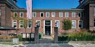 a brick building with a gate in front of it at The Anthony in Utrecht