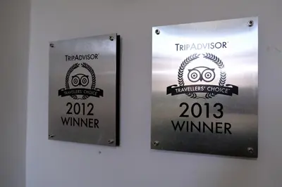 two signs hanging on a wall with a sign for a thanksgiving dinner at Studio Eelhouse in Amsterdam