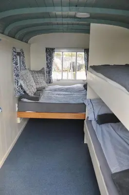 a bedroom with two bunk beds and a window at Bed & Breakfast ARKEN AE in Zuiderwoude