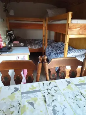 a room with two bunk beds and a table at Bed & Breakfast ARKEN AE in Zuiderwoude