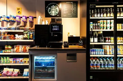 a bar in a store with a refrigerator and drinks at Cityden Stadshart in Amstelveen