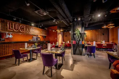 a dining room with tables and purple chairs at Cityden Stadshart in Amstelveen