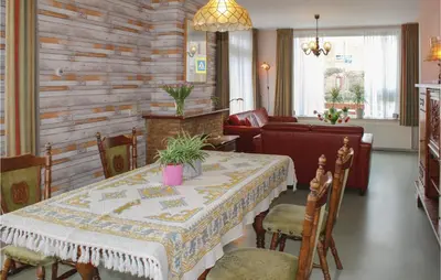 a dining room with a table and a couch at De Vissende Beer in Egmond aan Zee