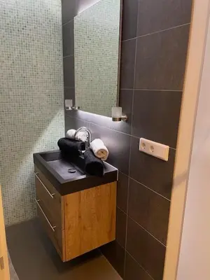 a bathroom with a sink and a mirror at Studio Black Jack in Amsterdam