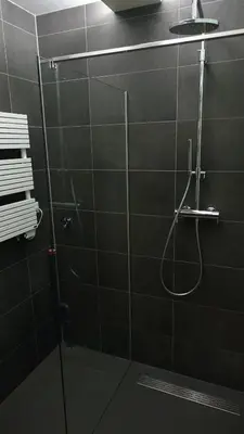 a bathroom with a shower with a glass door at Studio Black Jack in Amsterdam