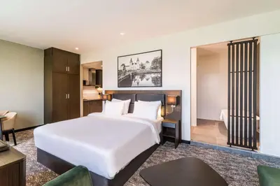 a bedroom with a large white bed in a room at Radisson Hotel & Suites Amsterdam South in Amstelveen