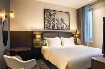 a hotel room with a bed and a chair at Radisson Hotel & Suites Amsterdam South in Amstelveen