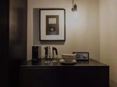a black cabinet with a coffee maker and a cup on it at Suite no 7, hidden gem center of Amsterdam in Amsterdam