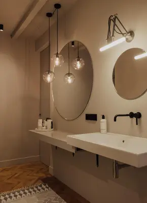 a bathroom with a white sink and two mirrors at Suite no 7, hidden gem center of Amsterdam in Amsterdam
