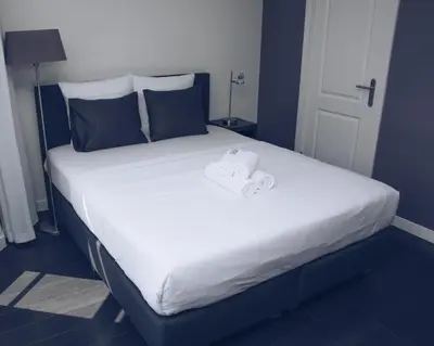 a large bed with two towels on top of it at Canal House Inn in Amsterdam