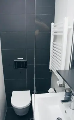 a bathroom with a white toilet and a sink at Canal House Inn in Amsterdam