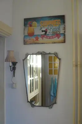 a mirror hanging on a wall in a room at Amsterdam Beach Apartment in Zandvoort