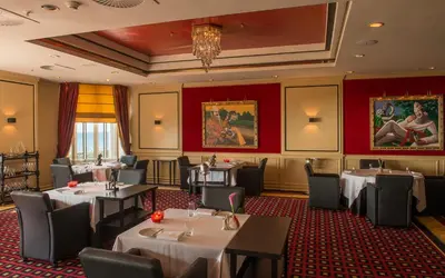 a restaurant with tables and chairs in a room at Grand Hotel Huis ter Duin in Noordwijk aan Zee