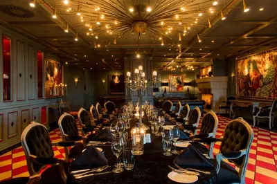 a long dining room with a long table and chairs at Grand Hotel Huis ter Duin in Noordwijk aan Zee