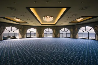 a large room with a chandelier on the ceiling at Grand Hotel Huis ter Duin in Noordwijk aan Zee