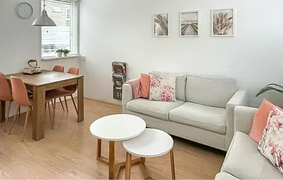 a living room with a couch and a table at Dophuisje in Egmond aan Zee