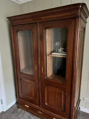 a wooden cabinet with glass doors in a room at Dahli's Sleep Boutique in Amsterdam