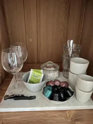 a tray with bowls and wine glasses on a table at Dahli's Sleep Boutique in Amsterdam