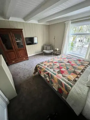 a bedroom with a bed and a large window at Dahli's Sleep Boutique in Amsterdam