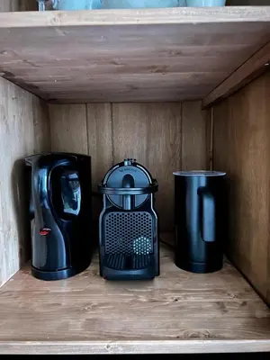 three appliances are sitting on a wooden shelf at Dahli's Sleep Boutique in Amsterdam
