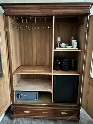 a wooden hutch with a tv in it at Dahli's Sleep Boutique in Amsterdam