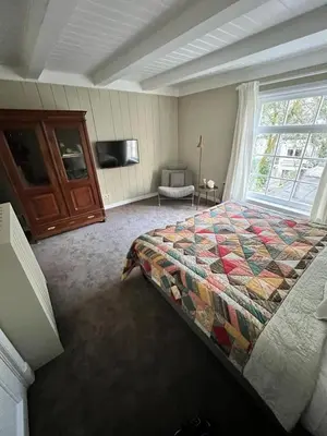 a bedroom with a bed and a large window at Dahli's Sleep Boutique in Amsterdam