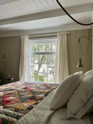 a bedroom with a large bed with a window at Dahli's Sleep Boutique in Amsterdam